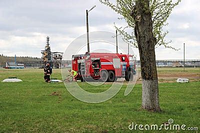 A Large Red Fire Rescue Vehicle A Truck To Extinguish A Fire And Male