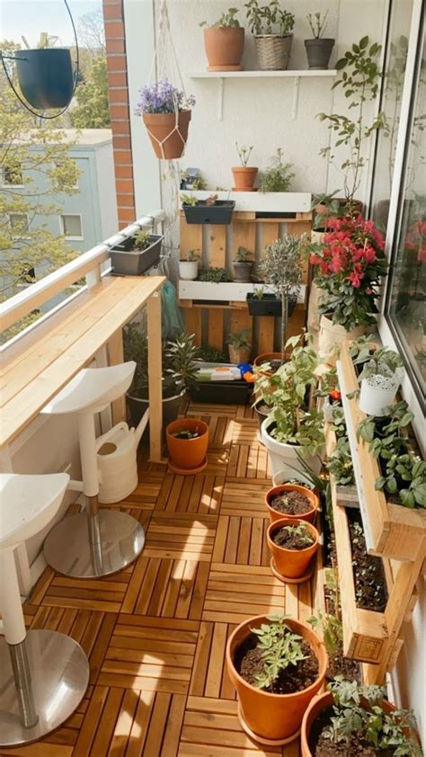 The Balcony Is Filled With Potted Plants And Hanging Planters On The