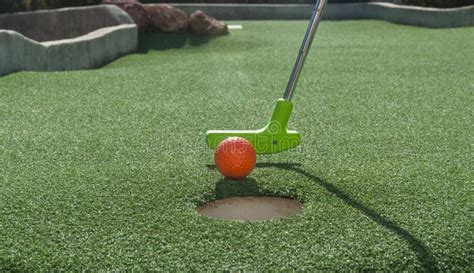 Miniature Golf Putter Tapping Ball Into Hole Stock Photo Image Of