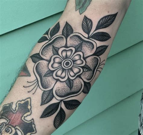 Tattoo On A Forearm Of A Black And White Flower And Leaves Boss Tattoo