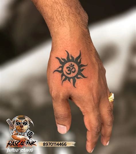 A Person S Hand With A Tattoo On It And An Om Symbol In The Middle