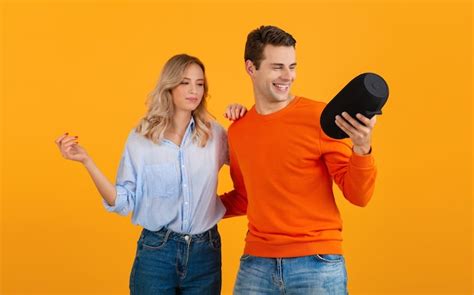 Free Photo Beautiful Smiling Young Couple Holding Wireless Speaker