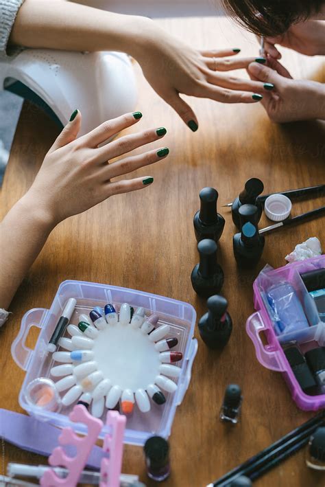 Girls Applying Nail Polish To Friend By Stocksy Contributor MaaHoo