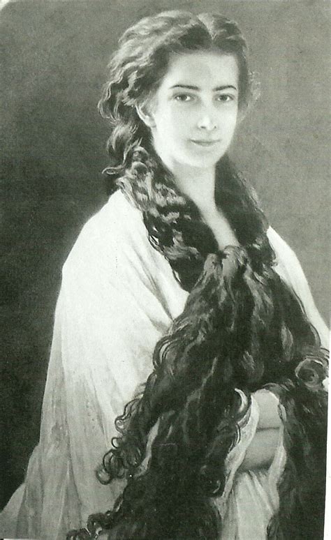 An Old Black And White Photo Of A Woman With Long Hair