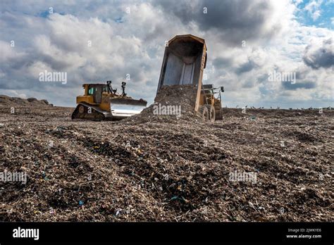 A Dumper Truck On A Large Waste Management Landfill Site Dumping