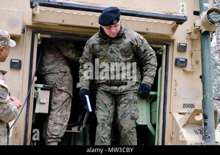 A Polish Soldier exits a M1068 Fire Direction Center Vehicle after members of Bravo Battery, 3rd ...