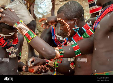 Men From The Hamar Tribe In Ceremony Need To Paint Their Faces That Will Be Helping With Holding