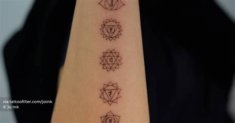 Fine line chakras tattoo done on the forearm.