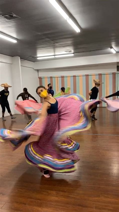 A Group Of People Are Dancing On A Wooden Floor