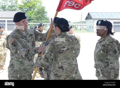 Incoming Commander CPT Dylan Knehr Accepts The Guidon From LTC Esther