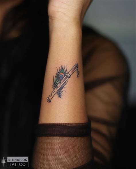 Peacock feather with flute tattoo | Hand and finger tattoos, Hand ...