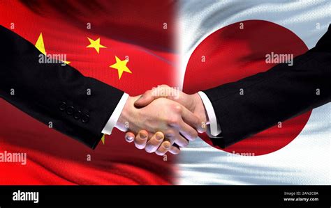 China and Japan handshake, international friendship relations, flag ...