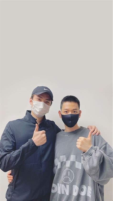 Two Men Wearing Face Masks And Giving Thumbs Up