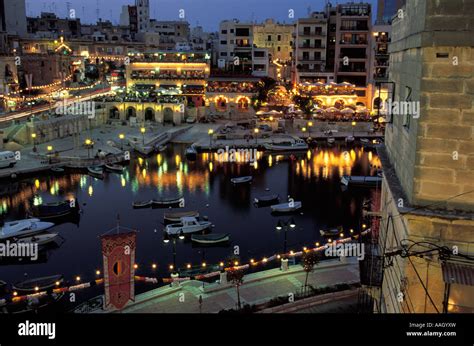 Restaurants And Harbour At Night Spinola Bay St Julian S Malta Stock