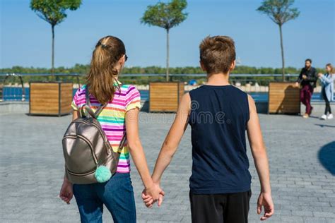 Teens Holding Hands Rear View. Friendship, First Love Stock Photo ...