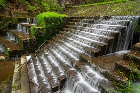 Picturesque Waterfall Cascading Down A Rocky Cliff Face Surrounded By