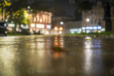 Night urban landscape, colored lights reflected in the wet asphalt in ...