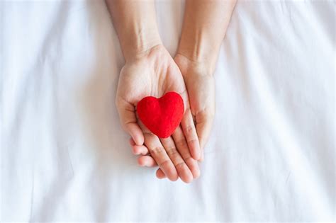 Premium Photo Woman Holding Red Heart Shape On White Background Close Up