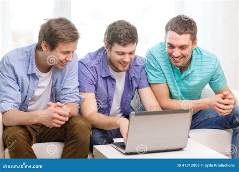 Smiling Friends With Laptop Computer At Home Stock Photo Image Of