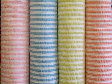 Four Different Colors Of Fabric Lined Up In Rows