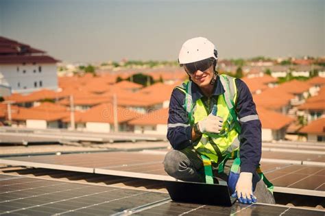 Engineer Installing Solar Panels Working On The Roof Stock Image