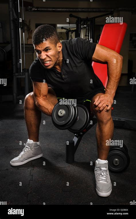 young man doing biceps curl workout in gym Stock Photo - Alamy