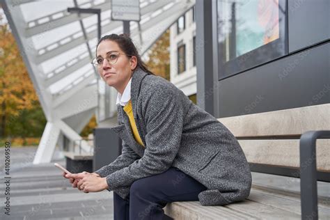 Thoughtful Female Professional Looking Away Holding Smart Phone While