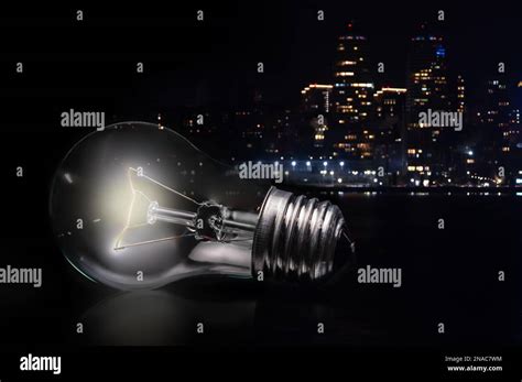 Close Up Of Tungsten Light Bulb With Glow On Dark Background And Night