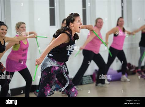 Women participating in POUND fitness class, hour long workout drumming ...