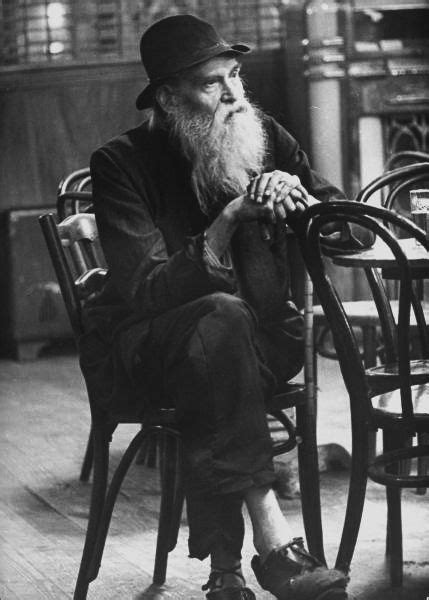 An Old Man Sitting Alone At A Table In A Bar Photograph By Alfred