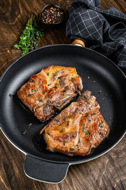 Premium Photo Roasted Pork Steaks In Frying Pan From Neck Meat Dark