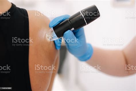 Doctor And Female Client In Dermatology Clinic Macro Photo Of