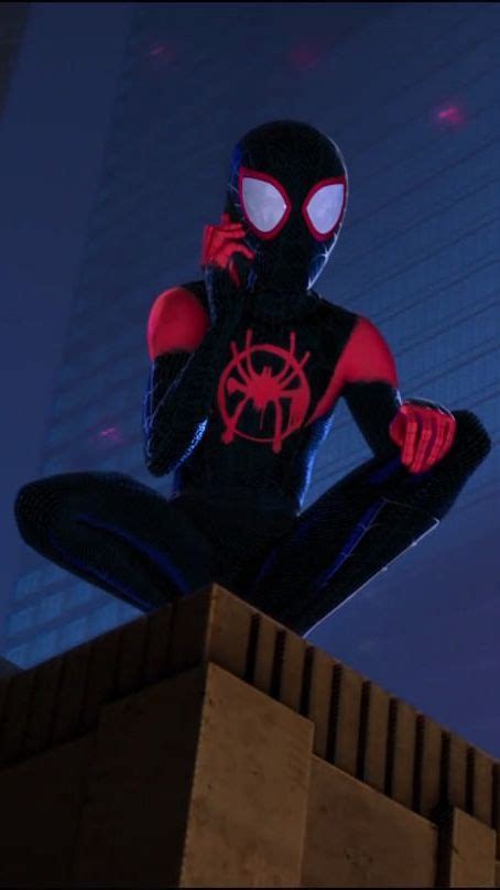 A Spider Man Sitting On Top Of A Building