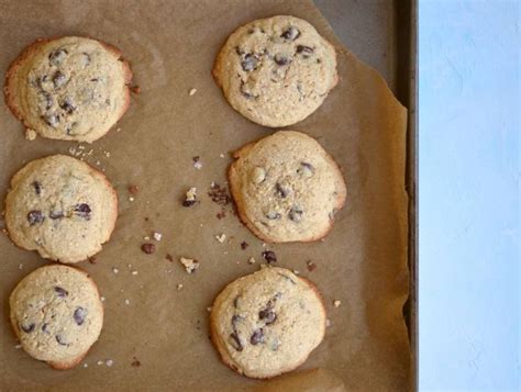 Six Chocolate Chip Cookies Sitting On Top Of A Cookie Sheet