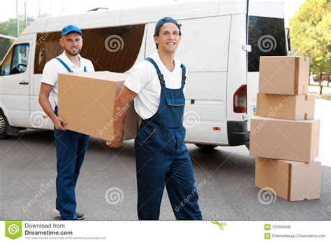 Male Movers Unloading Boxes From Van Stock Photo Image Of Deliver