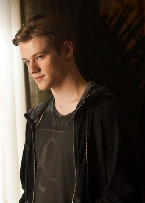 a young man standing in front of a window