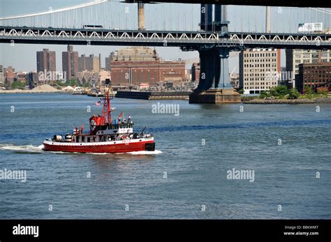 New York City Fireboat passing under the Brooklyn Bridge Brooklyn ...