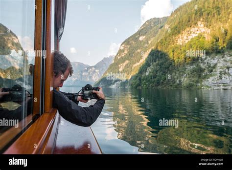 Man Tourist Photographing From Excursion Ship At Königssee National