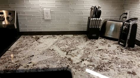 Alaska White Granite Countertop With Glass Tile Backsplash