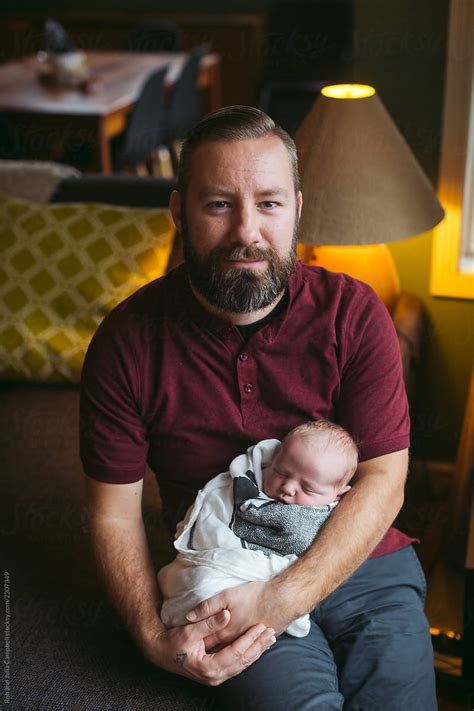 Man Holding Baby Indoors By Stocksy Contributor Rob And Julia