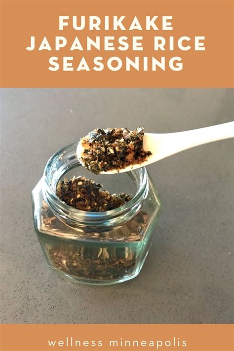 A Spoon Full Of Food Sitting On Top Of A Table Next To A Glass Jar