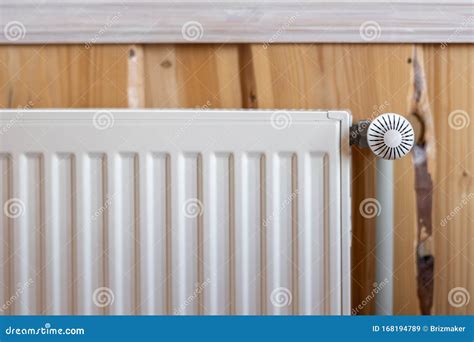 White Modern Radiator In Room With Wooden Wall And Cozy Interior Stock