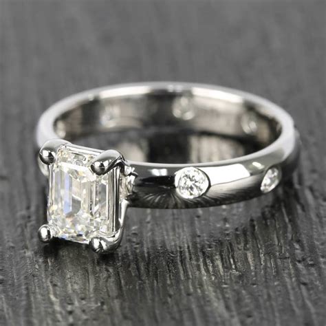 Inset Emerald Cut Diamond Engagement Ring In White Gold