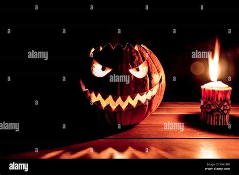 Spooky Smiling Halloween Pumpkin With Burning Fire Candle Flame Stock