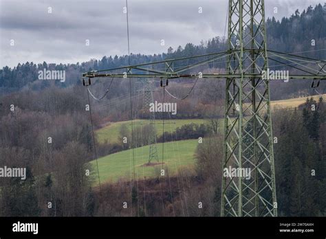 High Voltage Pylon In Rural Landscape With Dark Clouds Before A Storm