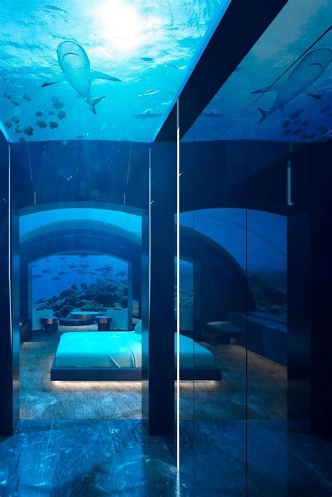 an underwater bedroom is lit up with blue lights