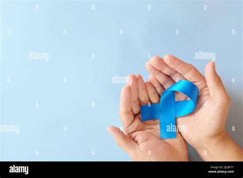 Top View Of Hands Holding Blue Awareness Ribbon Prostate Cancer Colon