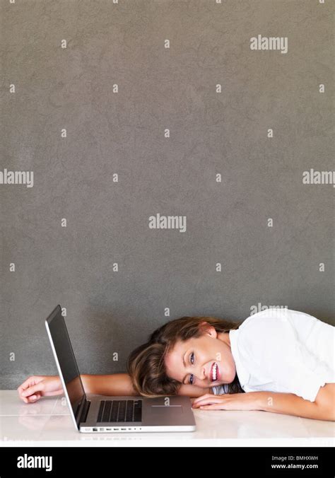 Tired woman in front of laptop Stock Photo - Alamy