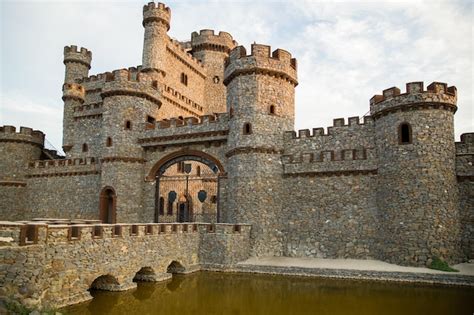 Premium Photo | Beautiful stone castle in the old style with a pond