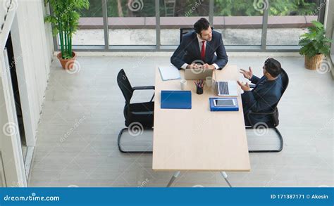 Business Background Of Two Businessmen Having Discussion Together In